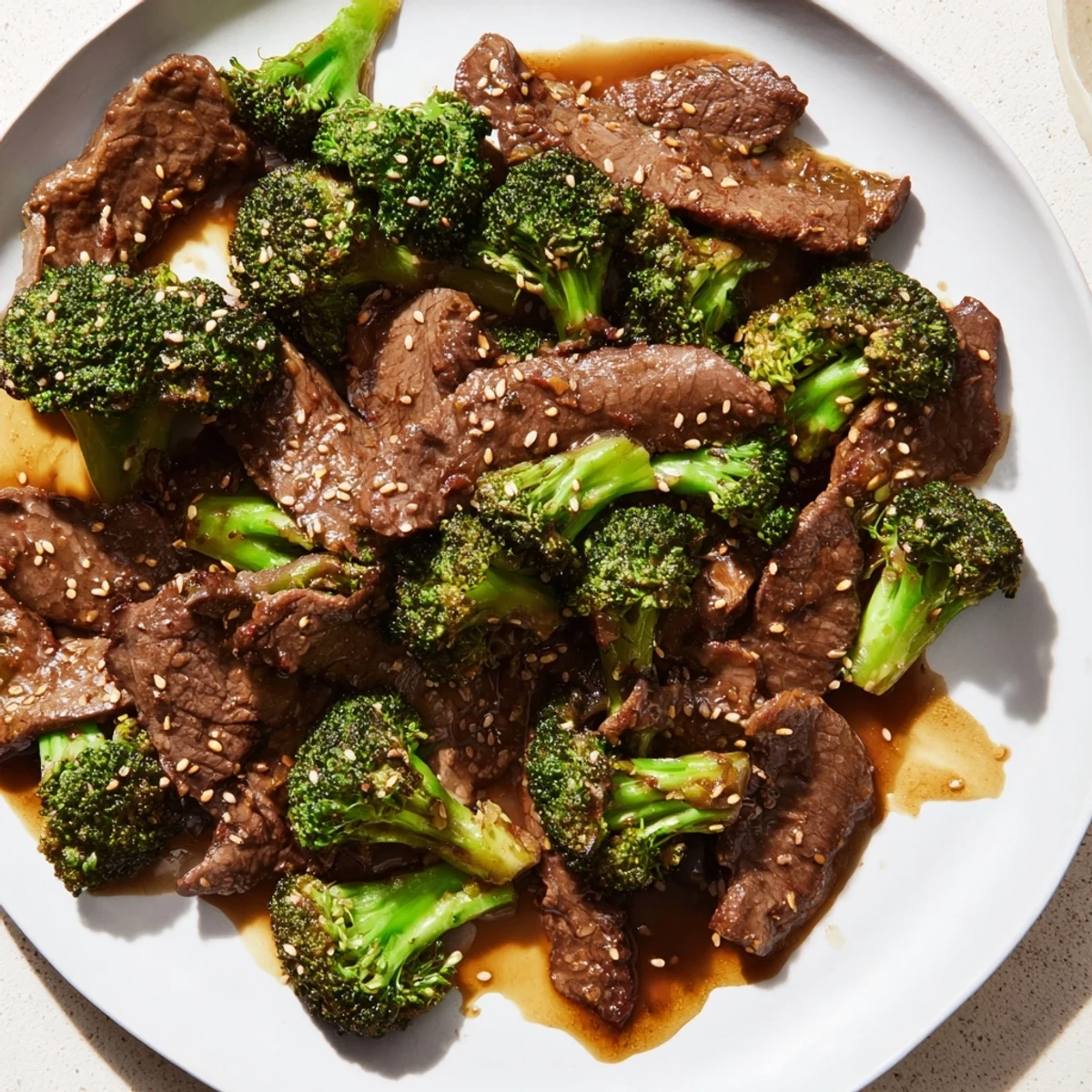 Better than takeout beef with broccoli served over steamed white rice with sesame seeds