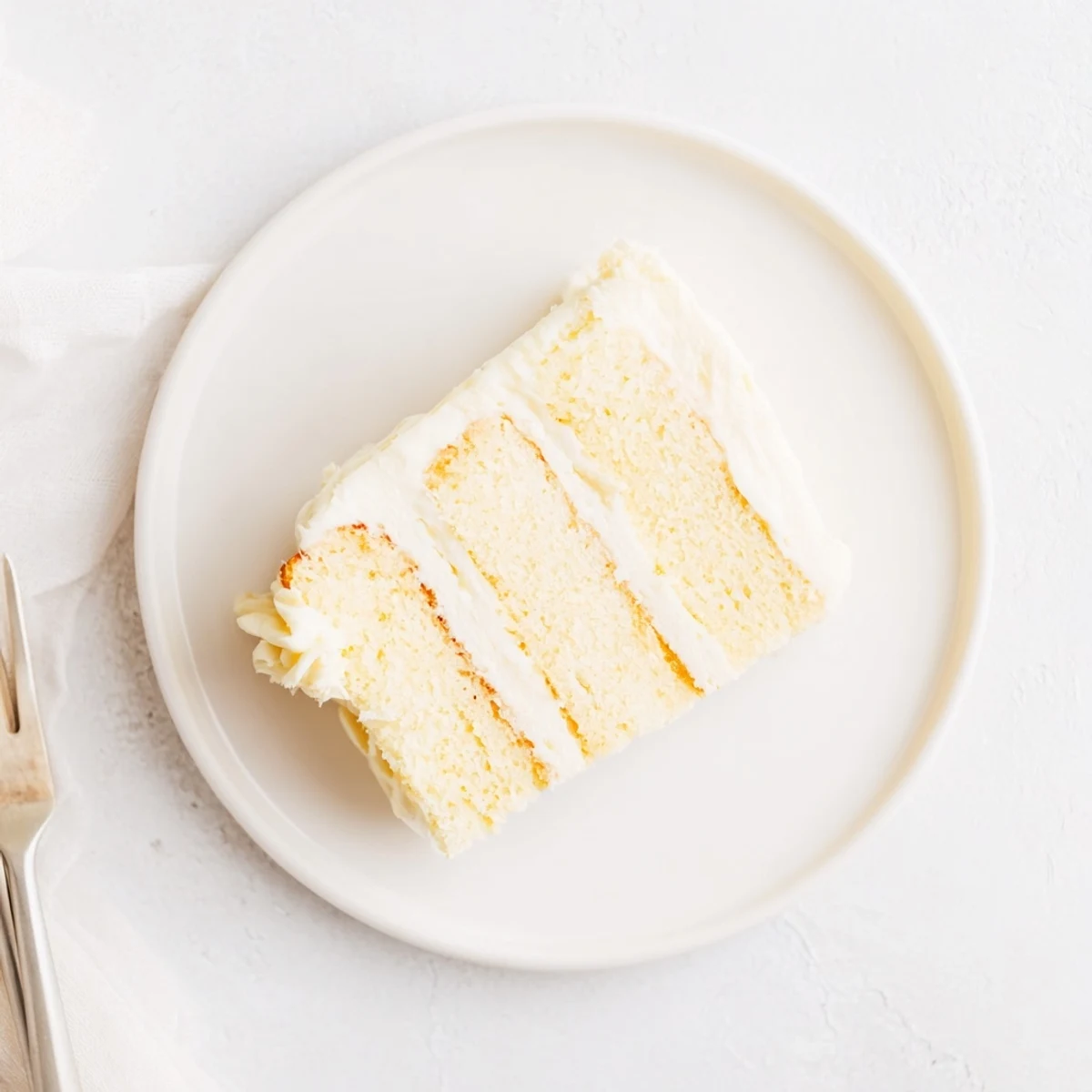 Round perfect vanilla cake frosted with smooth white buttercream and decorated for celebrations