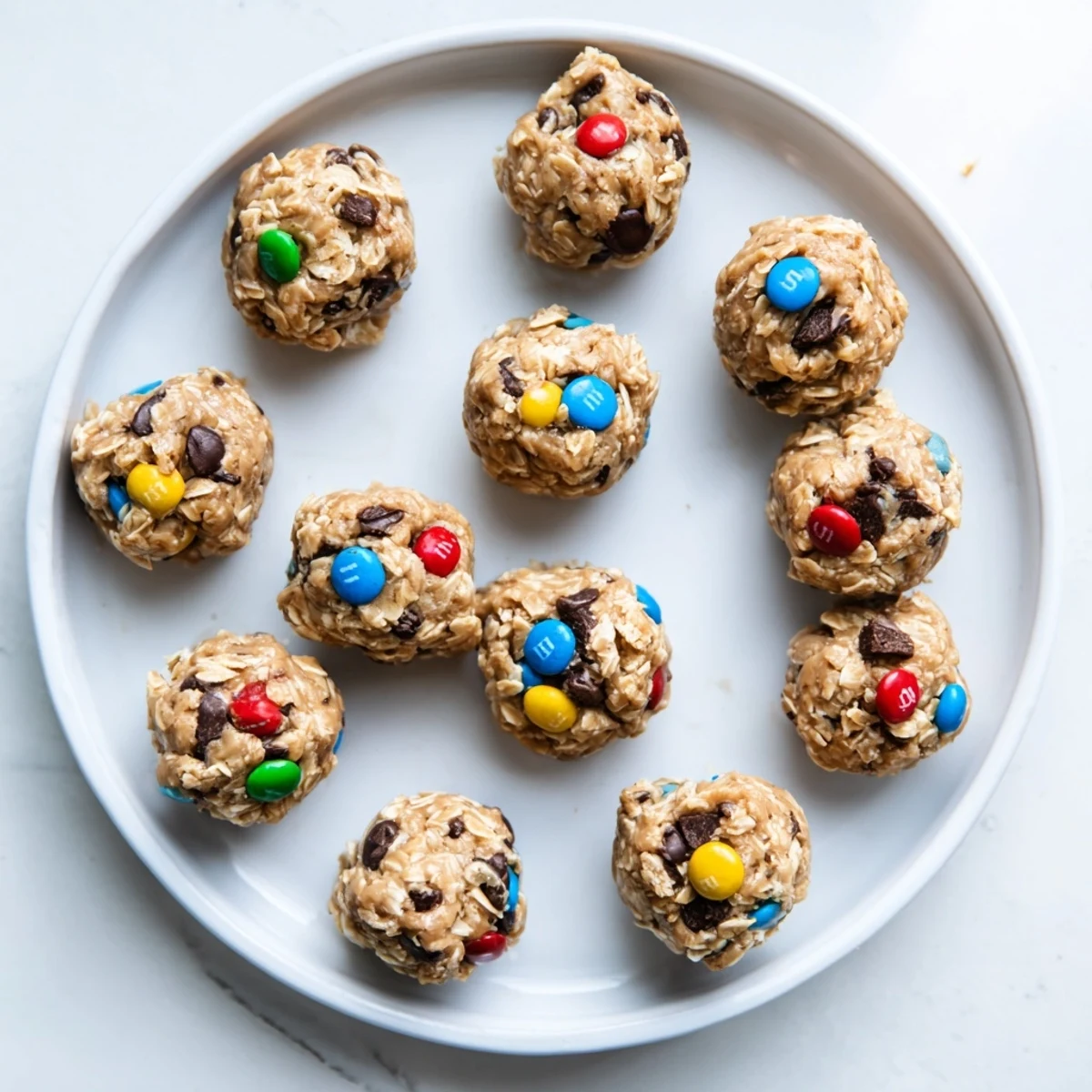Chewy monster cookie protein balls studded with colorful chocolate candies and peanut butter