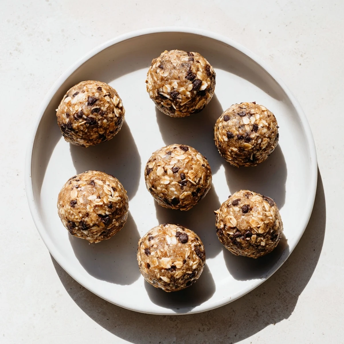 No-bake mint chocolate chip protein balls studded with mini chocolate chips and ready for snacking