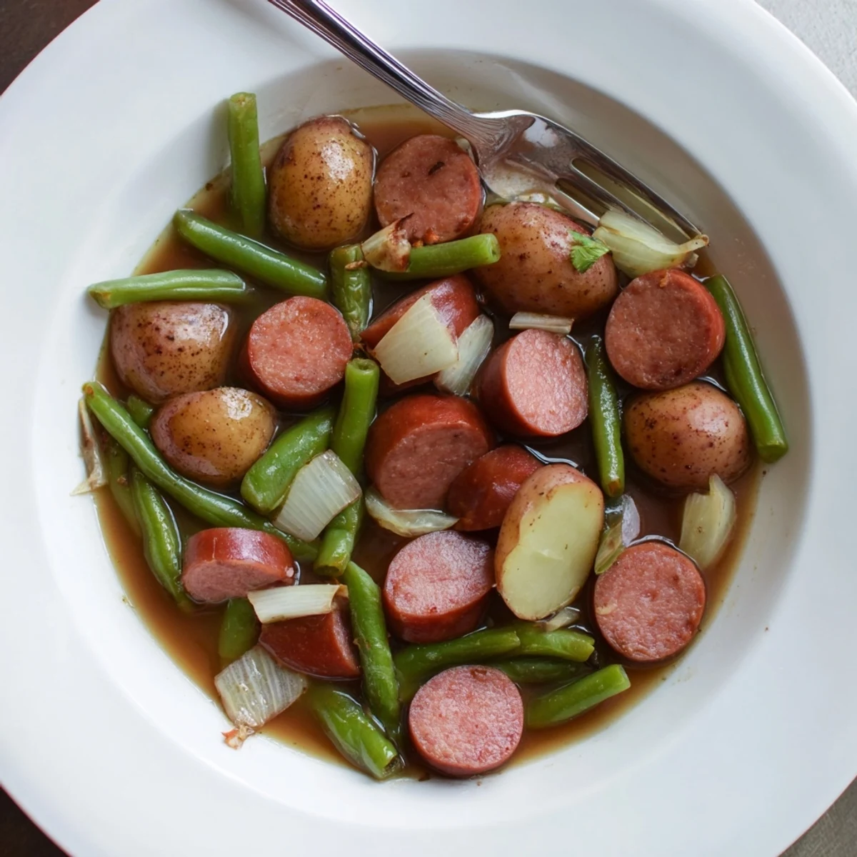 Slow cooker Crockpot Kielbasa and Green Beans with tender baby potatoes and sliced smoky sausage in a savory broth