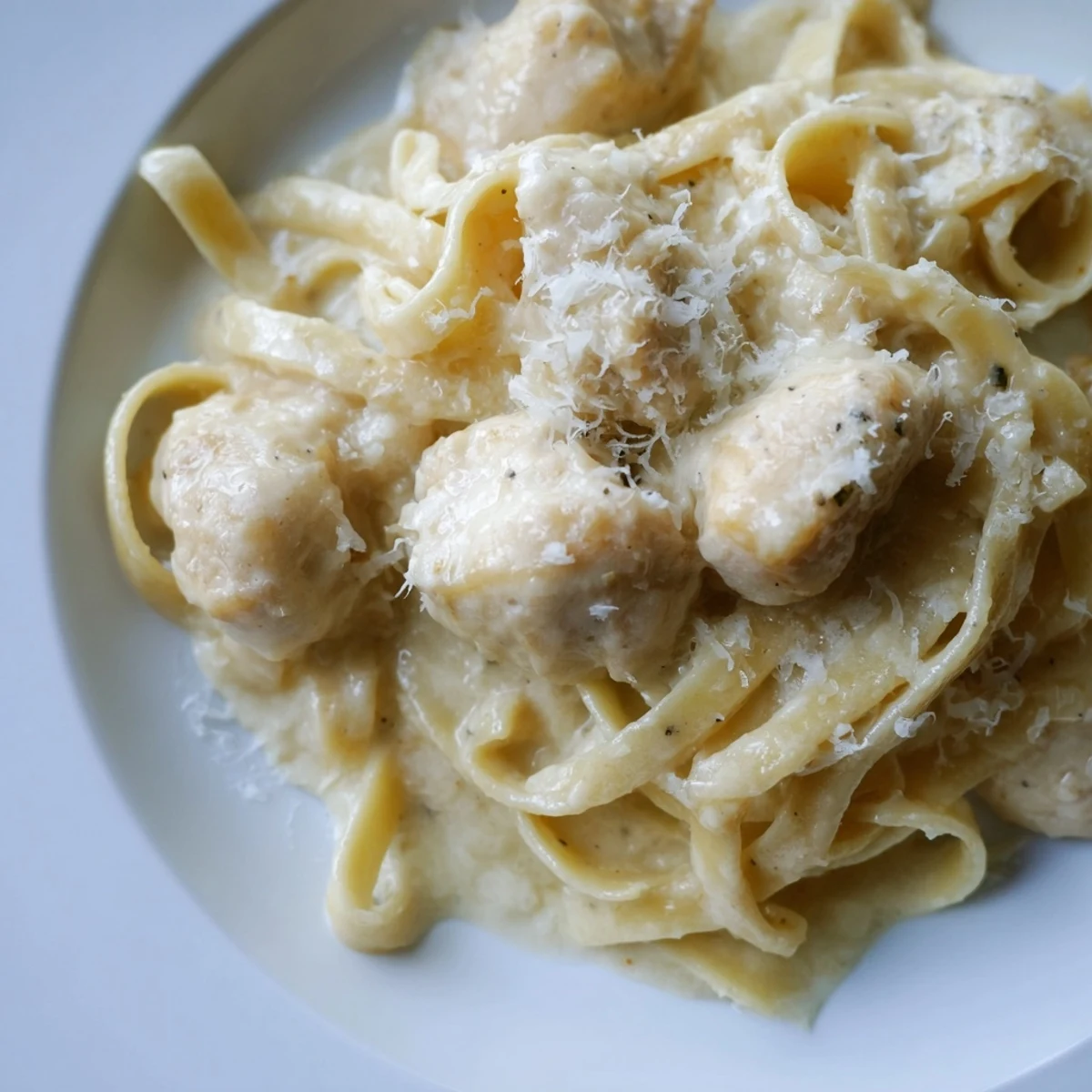 Golden chicken and al dente pasta swimming in a luscious white cheese sauce prepared in the pressure cooker