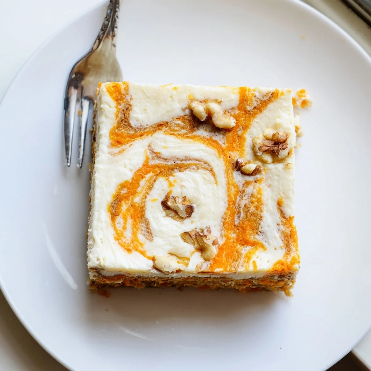 Moist carrot cake cream cheese bars with marbled cream cheese frosting and grated carrot speckles