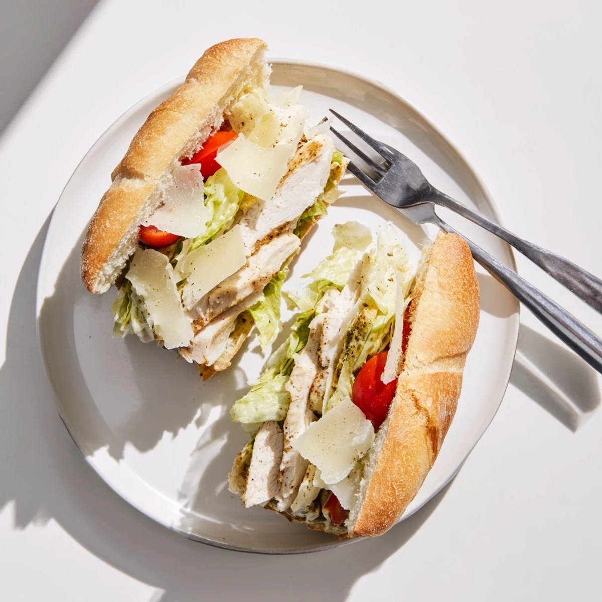 Toasted chicken Caesar sandwich layered with shaved Parmesan, fresh lettuce, and tangy homemade Caesar dressing