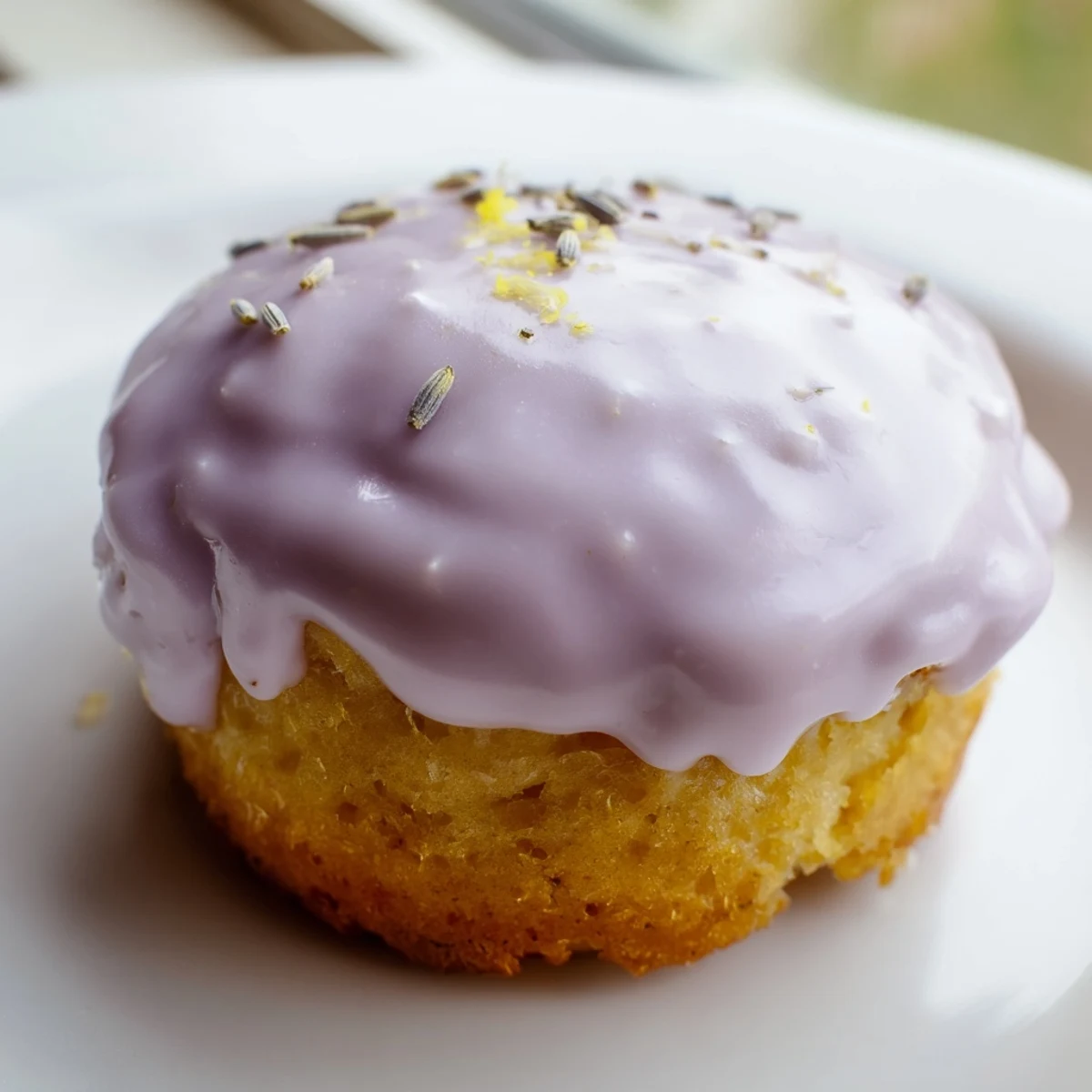 Golden mini lemon cakes with lavender glaze drizzled over tender crumb tops