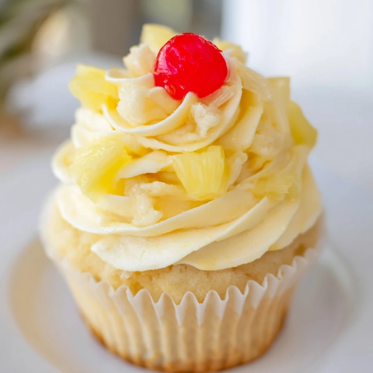 Dole Whip Cupcakes with tropical pineapple whipped cream on a bright yellow plate