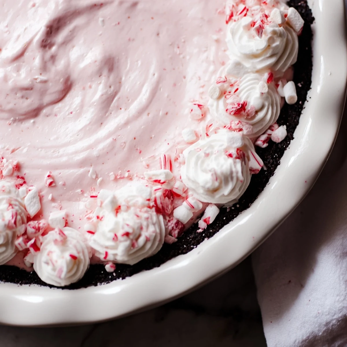 Candy Cane Pie with creamy peppermint filling, chocolate cookie crust, crushed candy canes