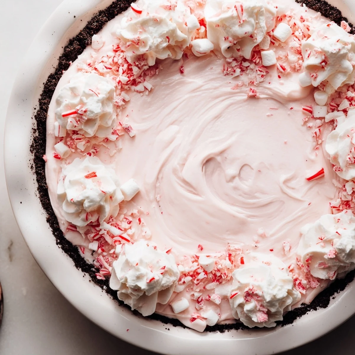 No-bake Candy Cane Pie showcasing fluffy cream, mini marshmallows, crunchy peppermint topping
