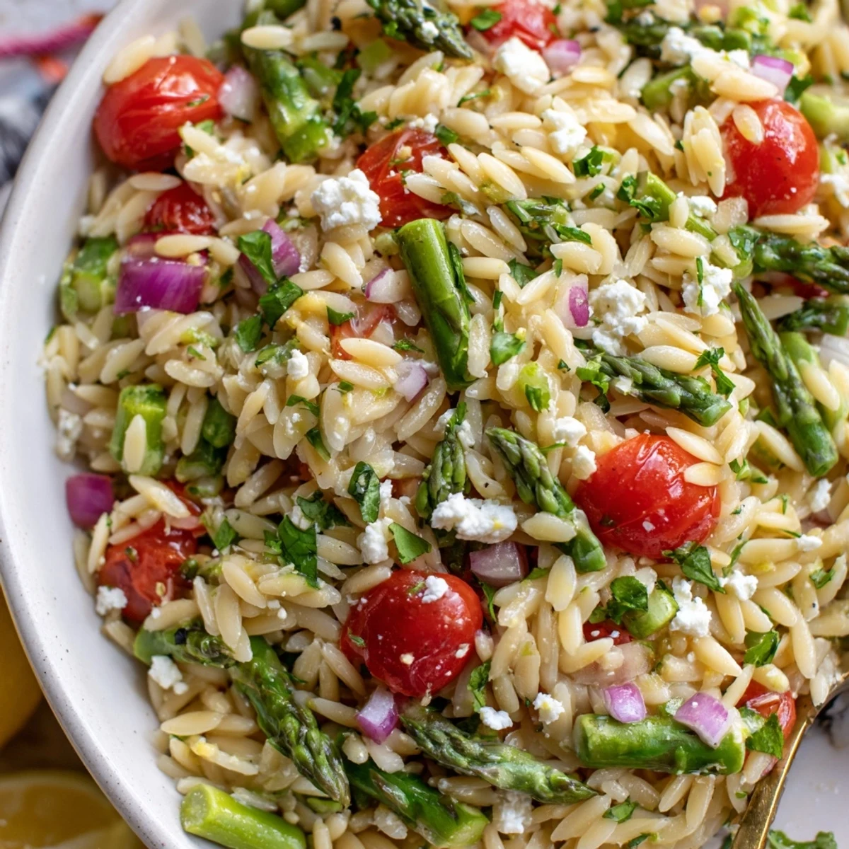 Chilled Asparagus Orzo Salad With Lemon Vinaigrette studded with cherry tomatoes, feta