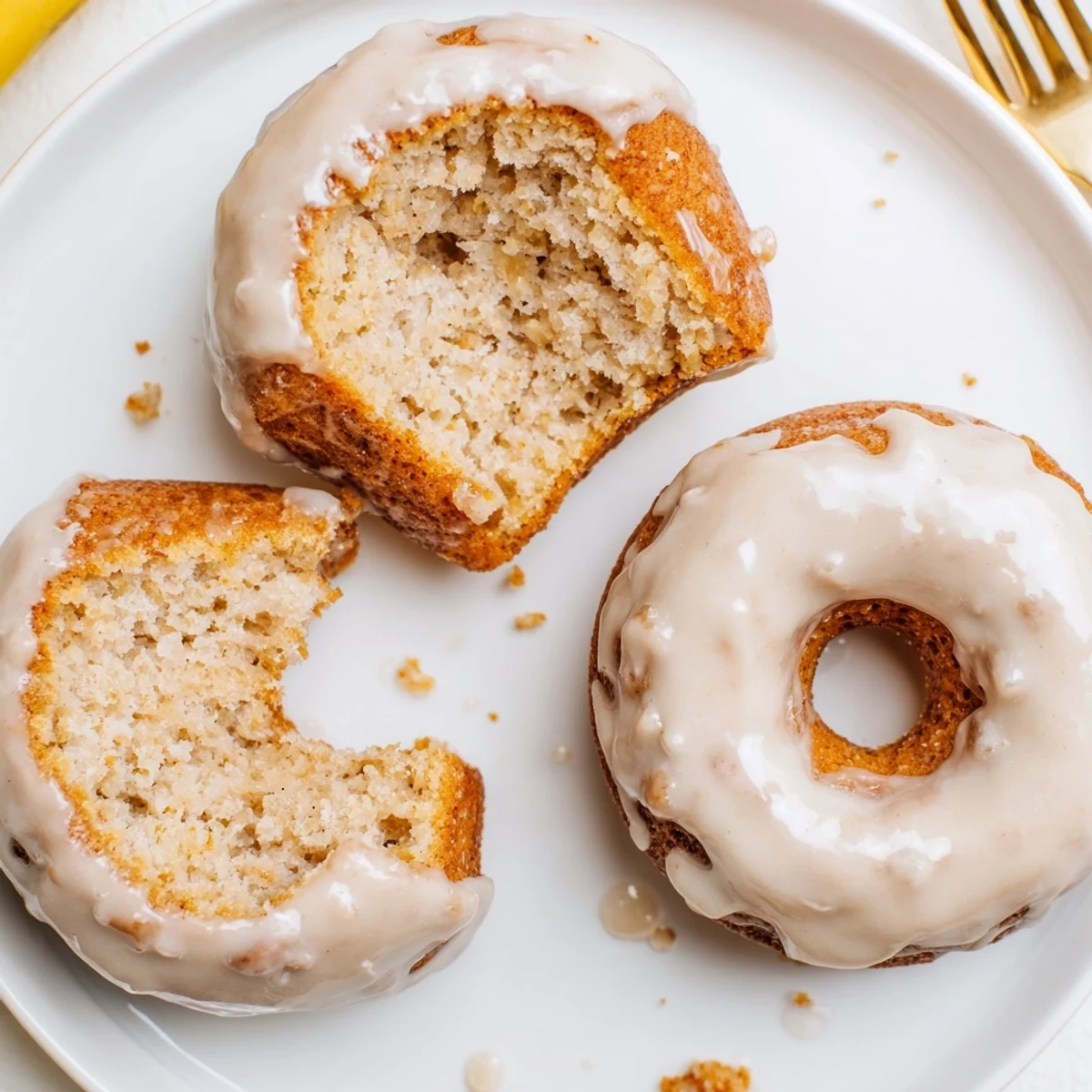 Warm Banana Donuts dipped in sweet vanilla glaze, soft cake texture.