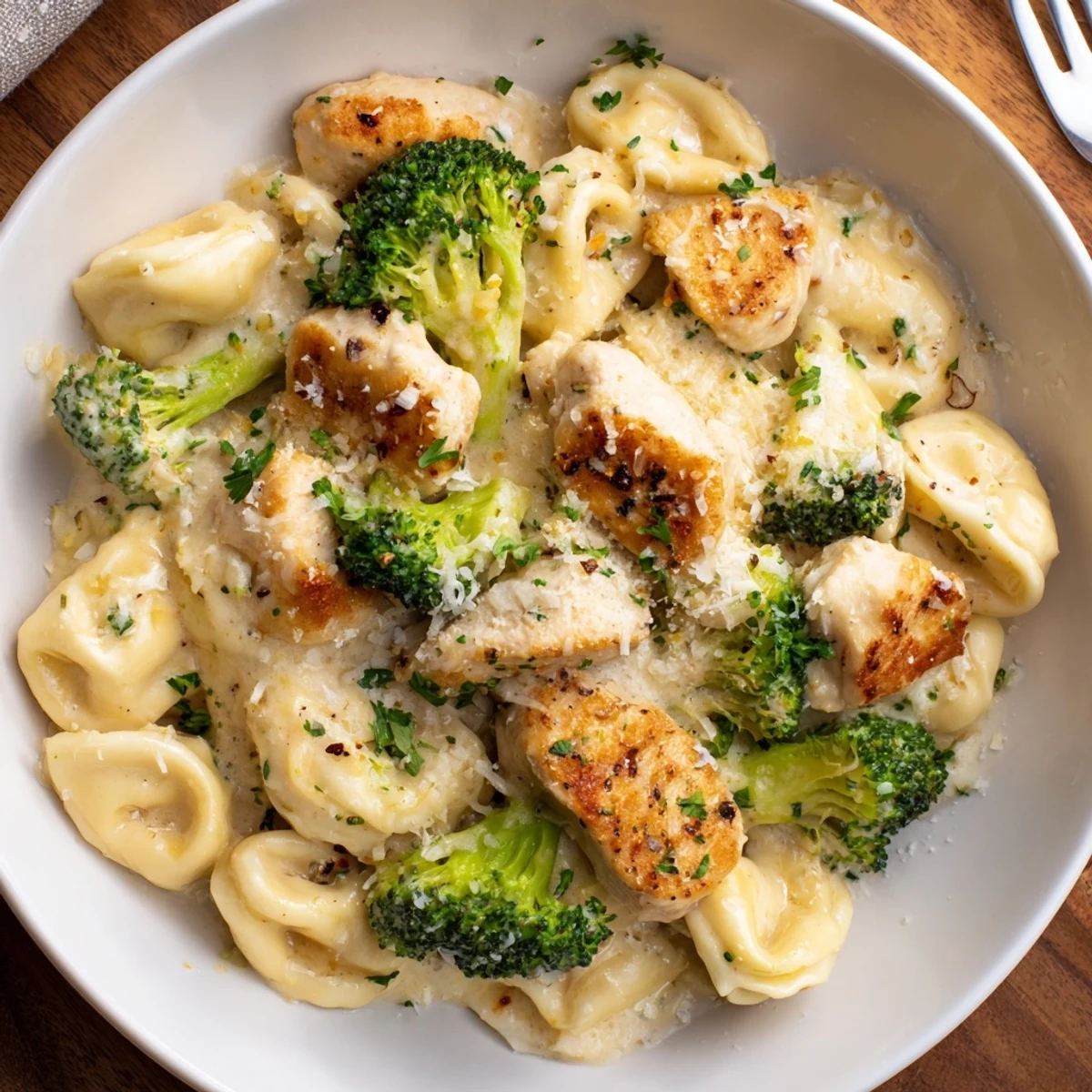 Creamy Garlic Parmesan Tortellini Chicken Broccoli plated steaming, tender chicken, crisp broccoli