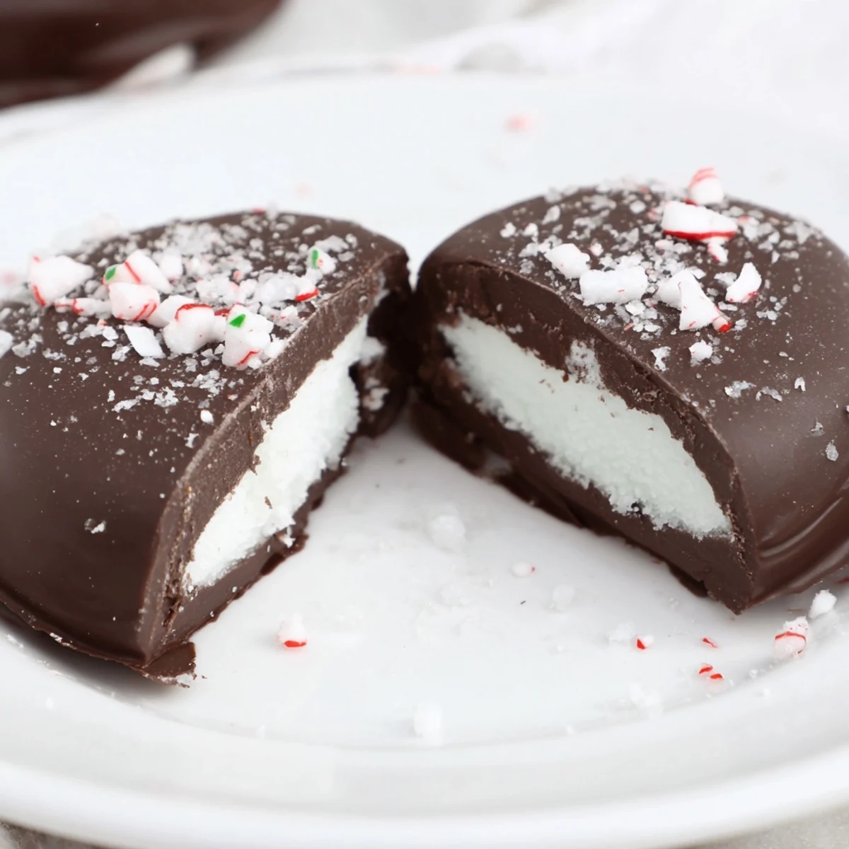 Stacked Peppermint Patties dusted with crushed peppermint candy, perfect after-dinner mint