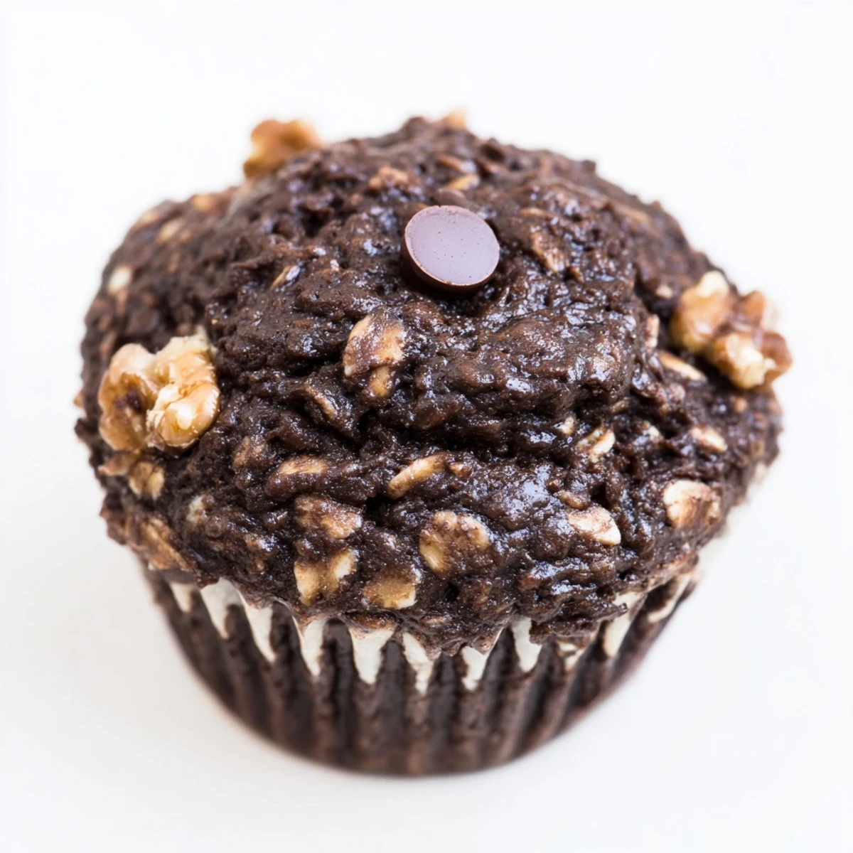 Freshly baked dark chocolate oatmeal cups topped with melted chips and chopped walnuts