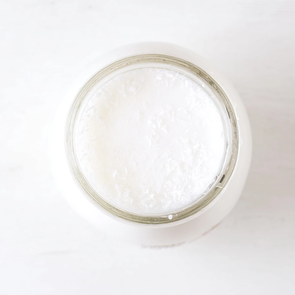 Fresh homemade coconut milk in blender with shredded coconut floating inside