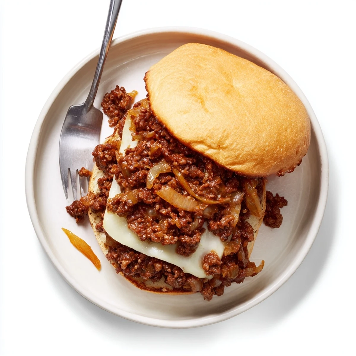 Hearty French onion beef sloppy joes sandwich featuring rich beef and onion mixture topped with bubbly Swiss cheese on soft hamburger buns
