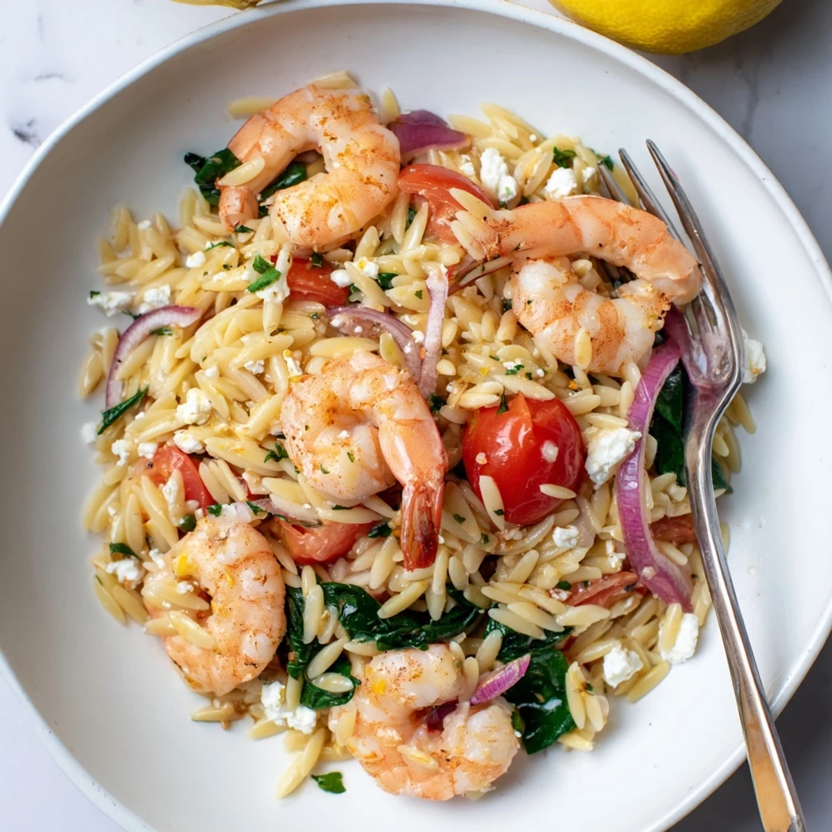 Topped with fresh parsley and lemon wedges, perfect Lemon Feta Orzo Shrimp Recipe