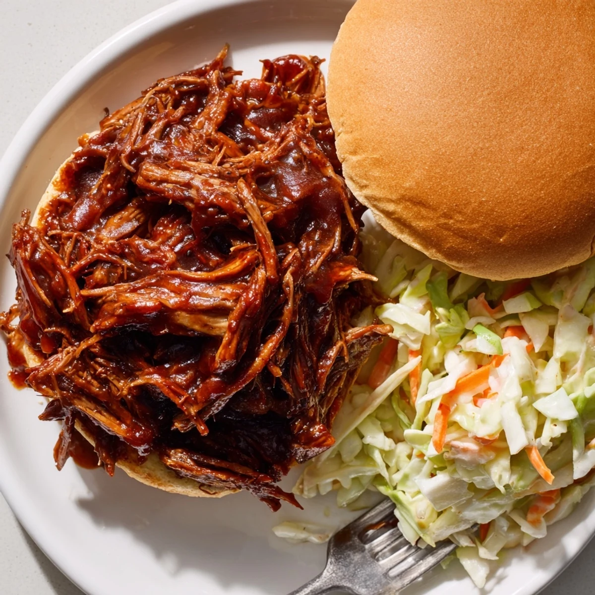 Slow Cooker BBQ Pulled Beef shredded finely and dripping with rich sticky sauce